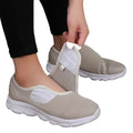 Women's Wide Fit Orthopedic Slip beige mesh shoes with white soles on a wooden floor.