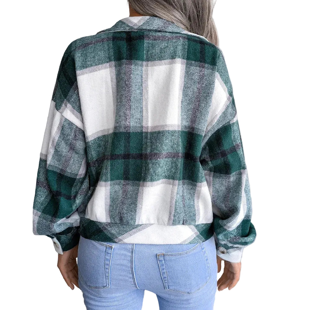 Person wearing a green and white plaid shirt in a minimal indoor setting