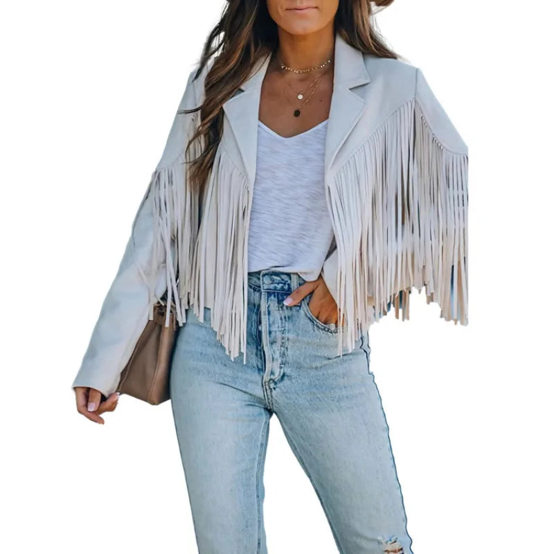 Woman wearing a light blue fringe jacket, white top, and jeans on a white background