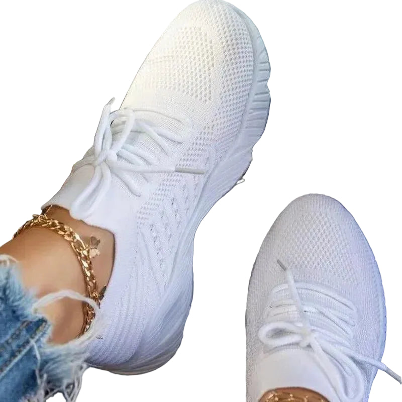 Women's white mesh sneakers with matching laces and textured soles at Casual Flow Shop