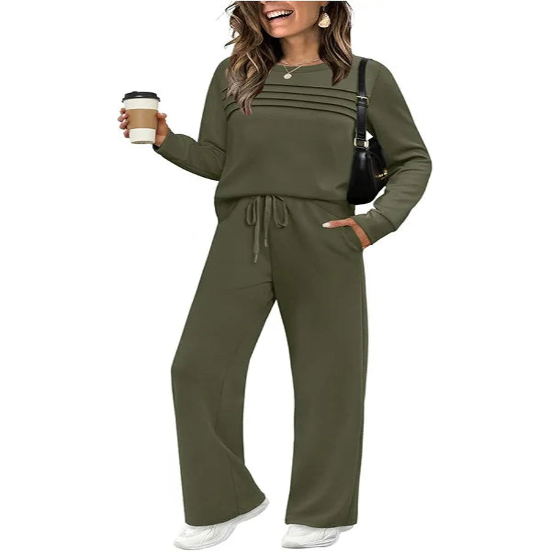 Woman wearing an olive green outfit holding a coffee cup on a white background