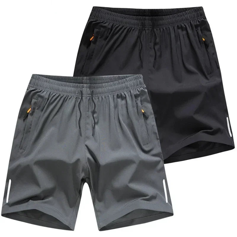 Two pairs of men’s lightweight quick dry shorts in black and grey with zipper pockets and elastic waistband