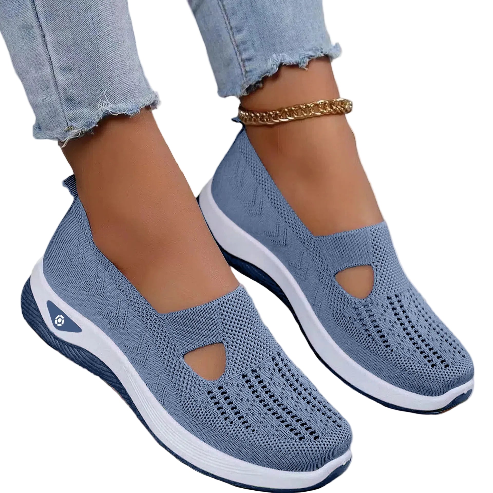 A pair of light blue women's casual walking shoes with a slip-on design, shown being worn by a person standing on a white surface. The shoes feature a breathable knitted mesh upper and a lightweight sole with anti-slip grip.