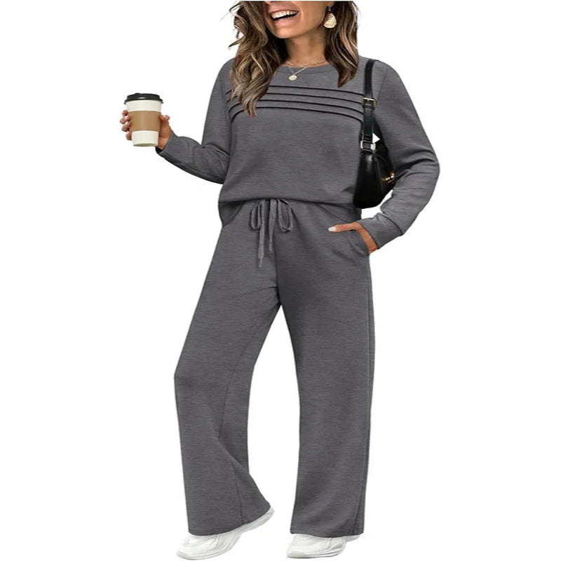 Woman wearing a gray lounge set holding a coffee cup on a white background