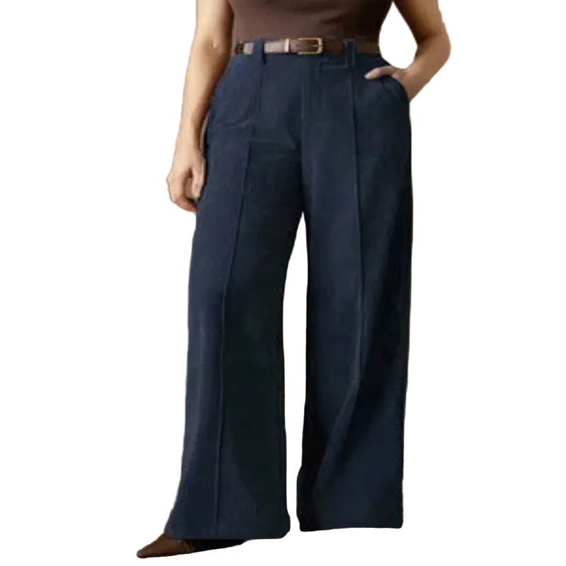Person wearing blue wide-leg pants in a vintage room setting