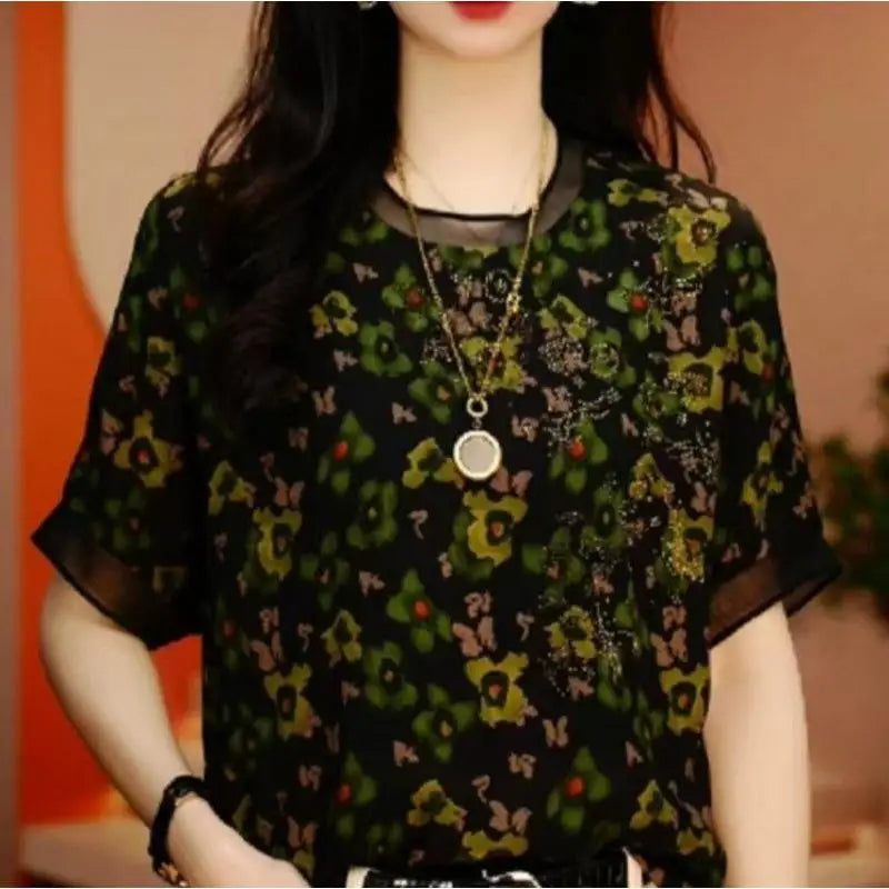 Person wearing a floral patterned top with a blurred background