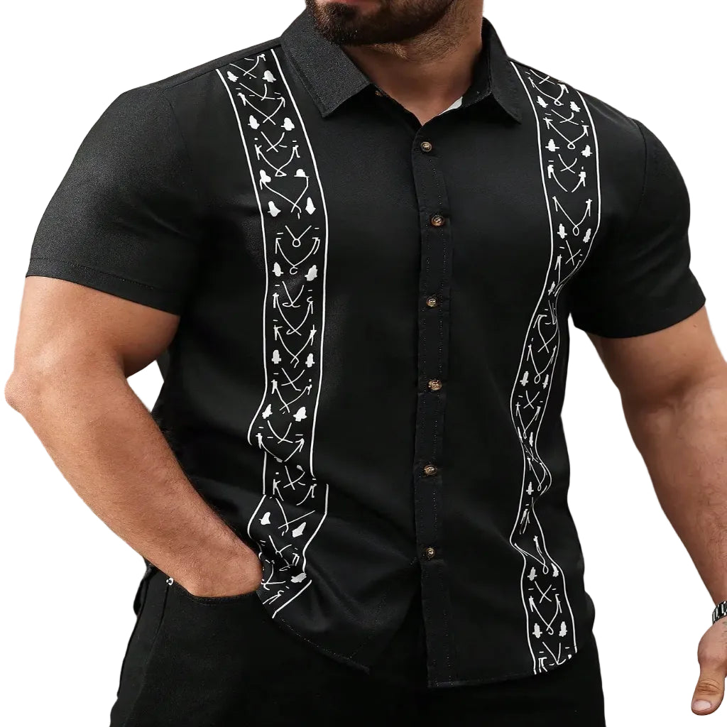 Black guayabera shirt with white embroidery worn by a person, blurred background