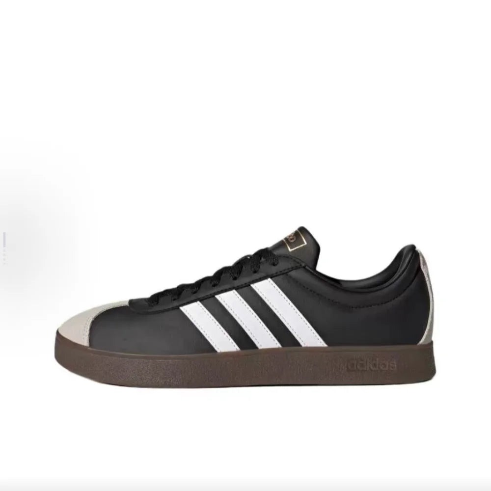 Black Retro Low Top Sneakers with white stripes on a white background