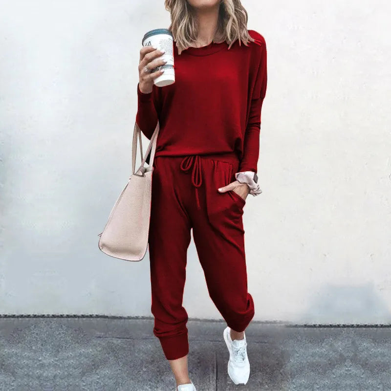 Person wearing a red outfit holding a coffee cup against a plain background