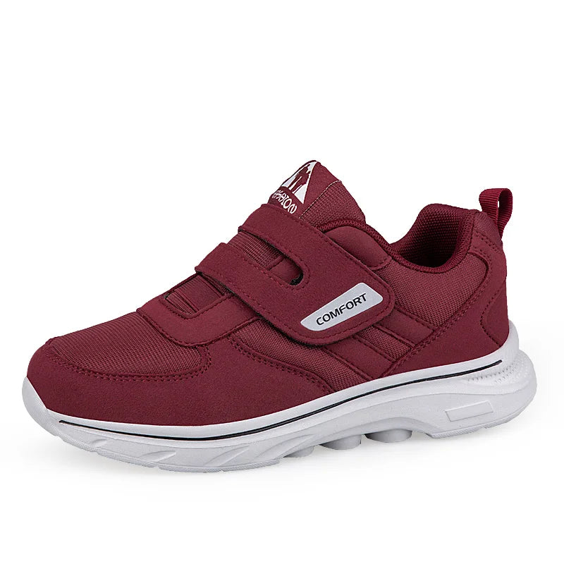 Maroon children's shoe with a white sole on a white background