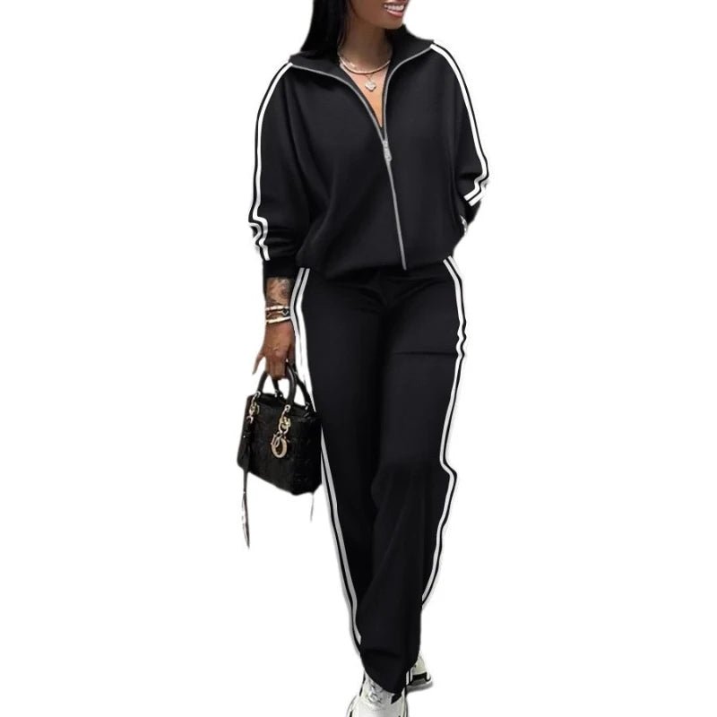 Person wearing a black tracksuit with white stripes on a white background