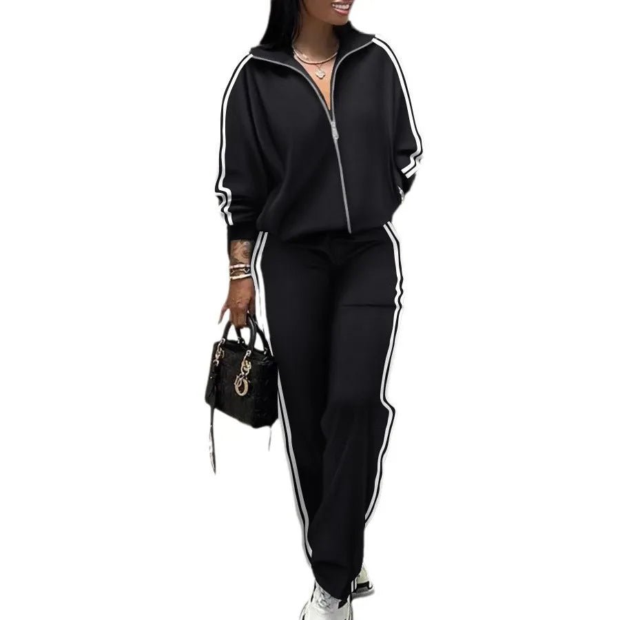 Person wearing a black tracksuit with white stripes on a white background