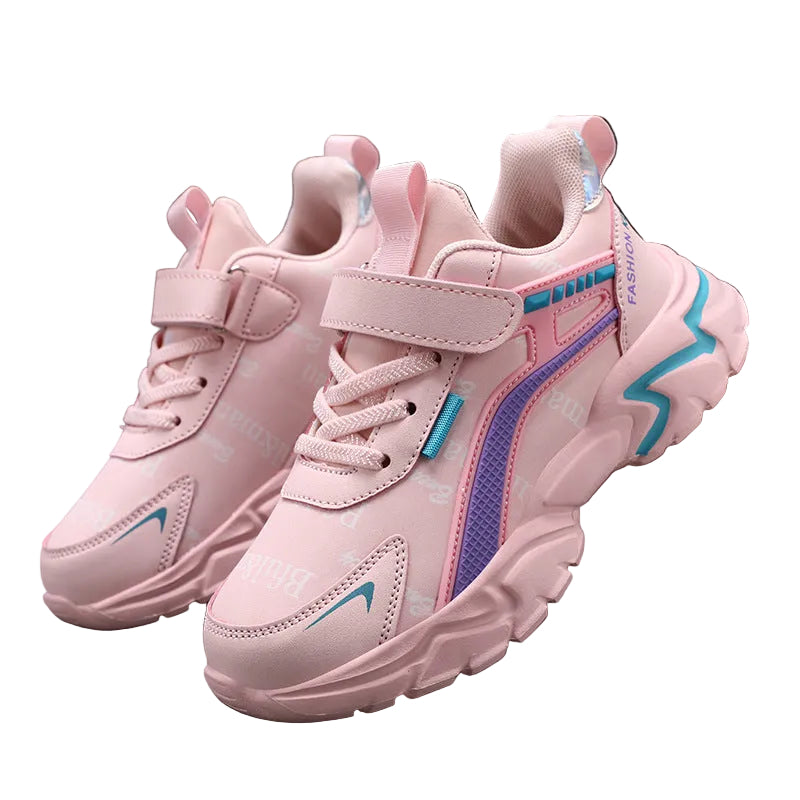 Pink children's sneakers with blue accents on a dark surface.