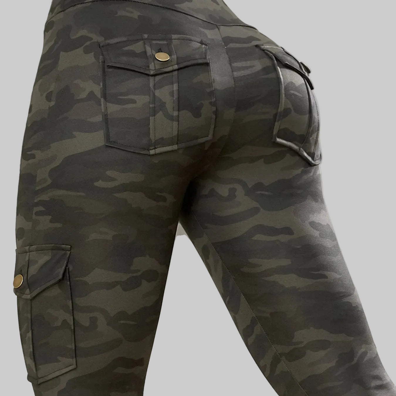 Camouflage cargo pants with visible buttons on a neutral background