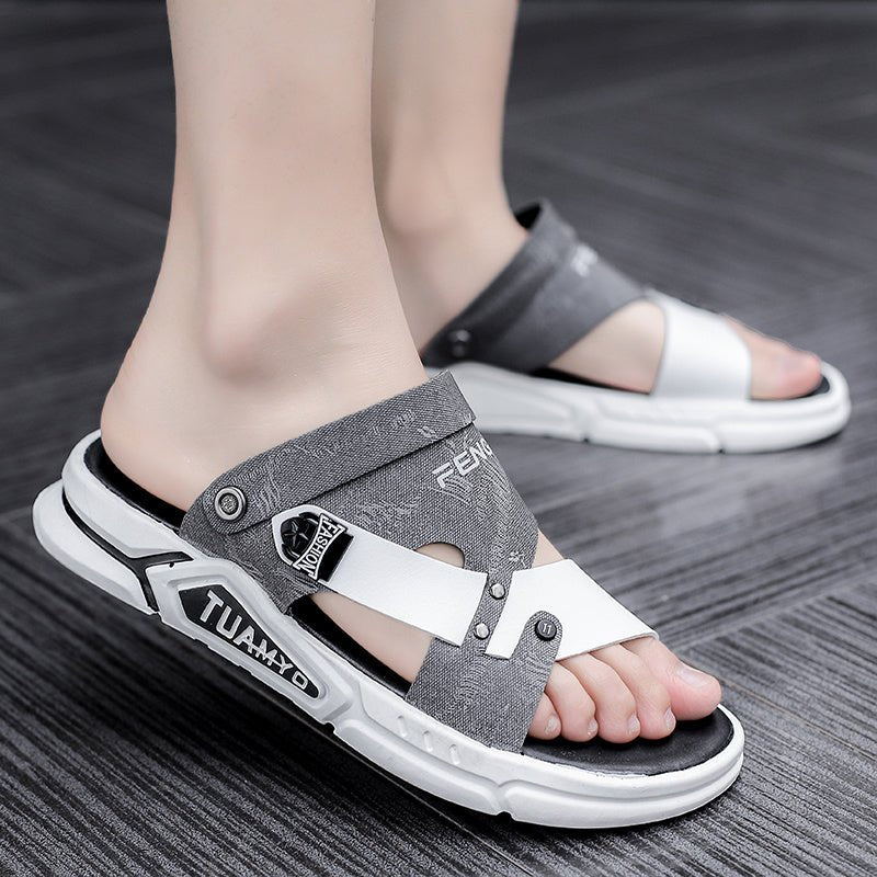 Gray and white sandals worn on feet on a wooden floor