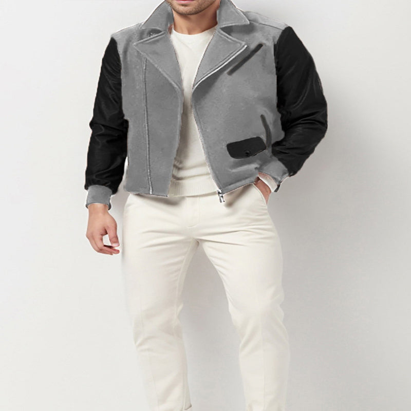 Person wearing a gray and black jacket with white pants on a light gray background
