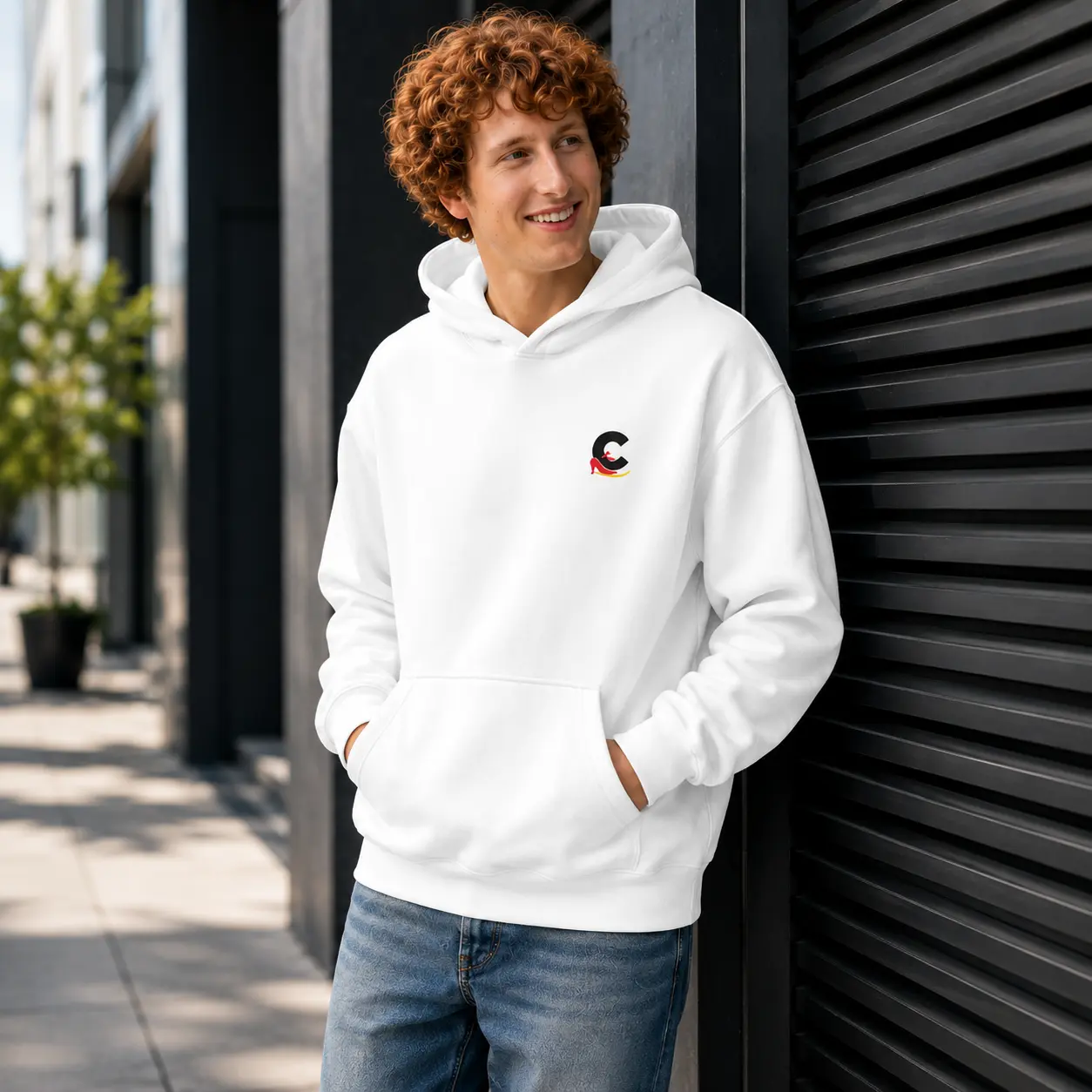 Young man wearing a white unisex streetwear logo hoodie by Casual Flow Shop